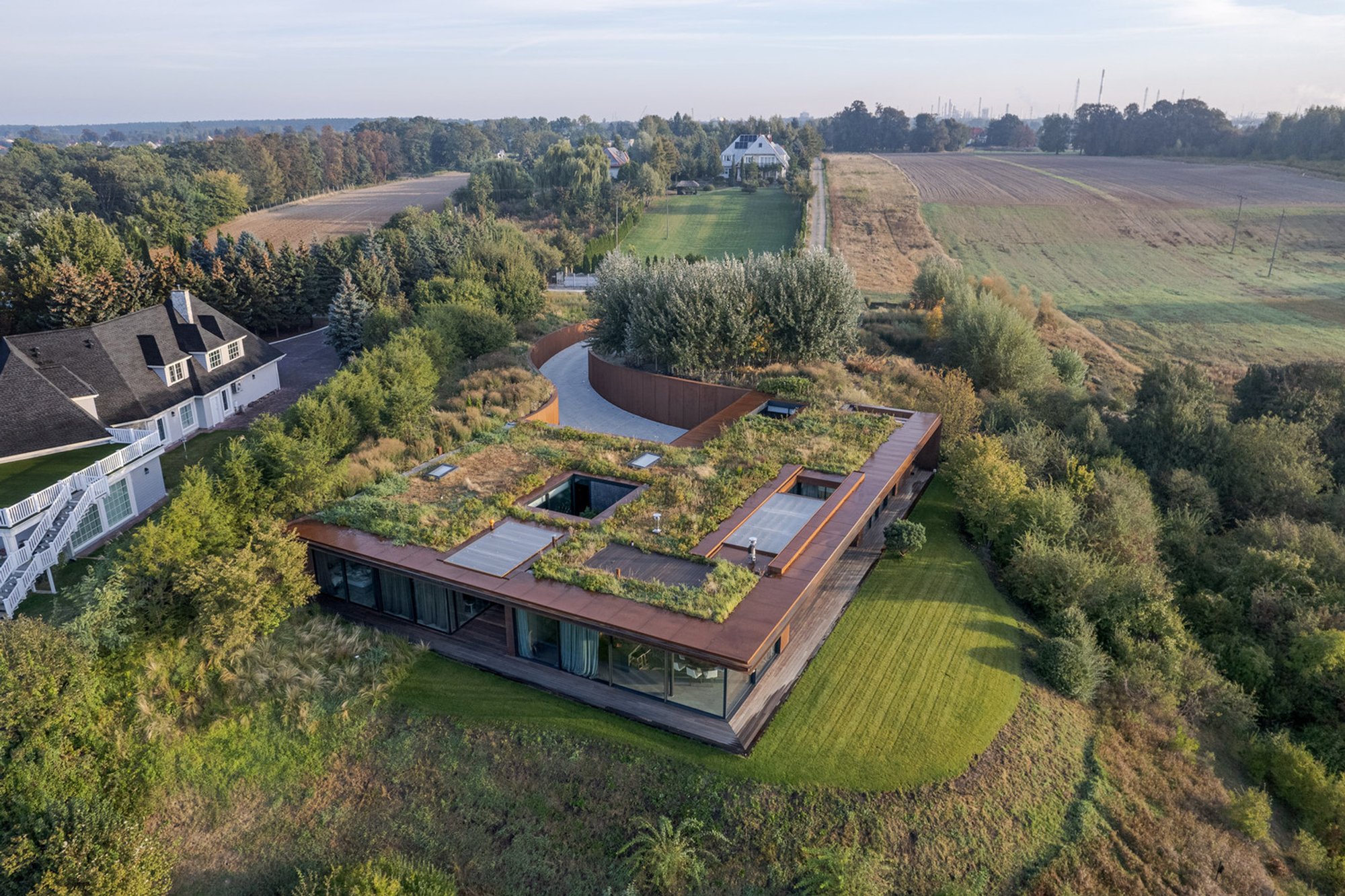 House in the Slope: A Modern Riverside Refuge by 77 Studio Architecture