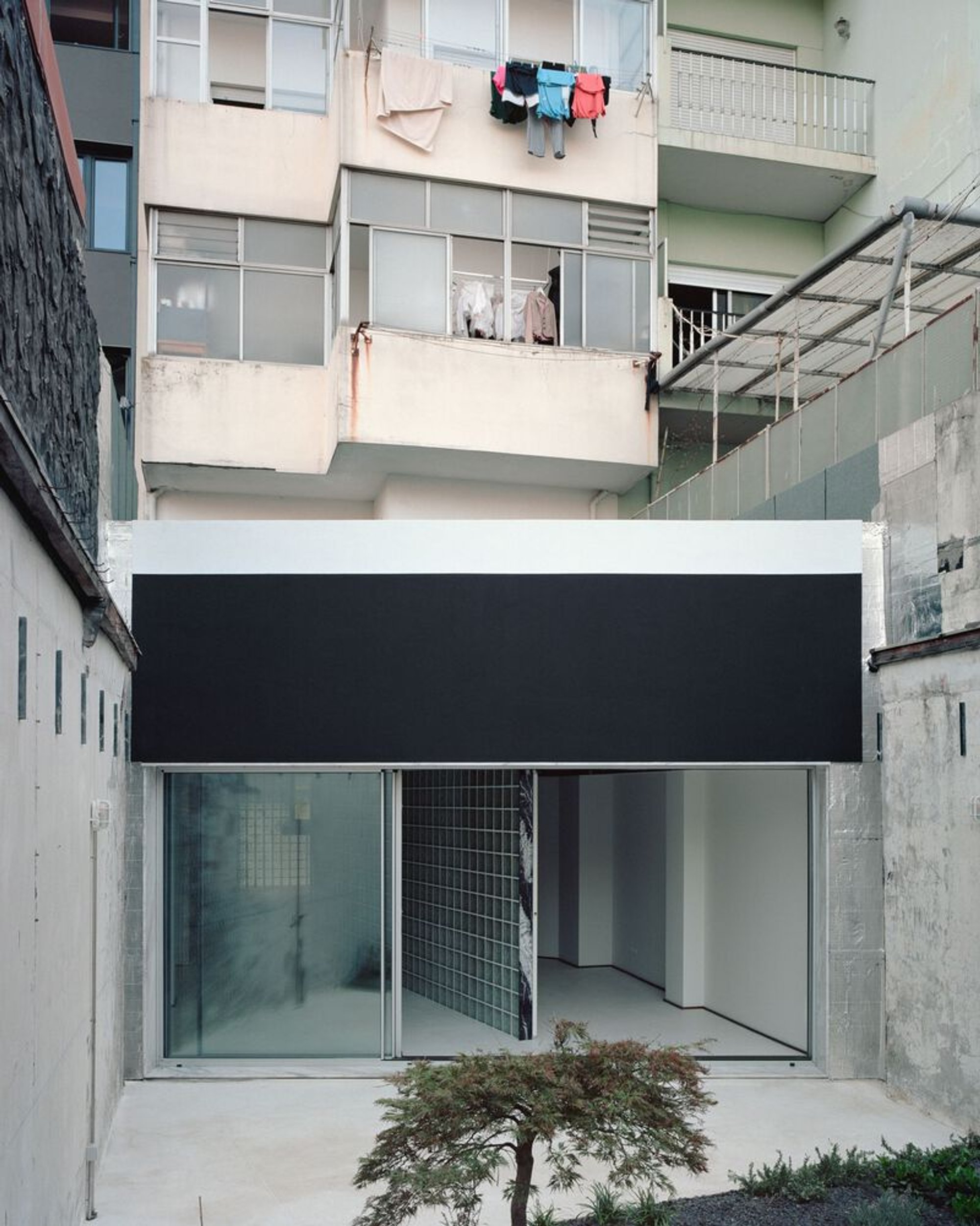 Oasis Under a Building by fala – Innovative Glass House in Porto, Portugal