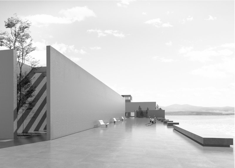 A minimalist outdoor terrace defined by monolithic walls and open views toward the coastal landscape.