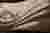 The image showcases a close-up of a draped fabric with a textured surface. The interplay of light an