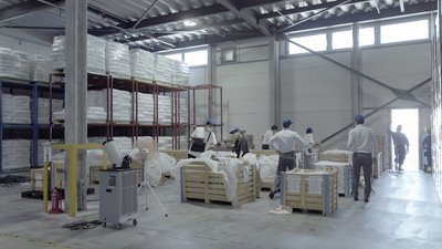 This image showcases the interior of a large industrial warehouse, characterized by its high ceiling