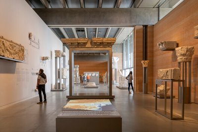 This architectural image showcases the interior of a modern museum, featuring a minimalist design wi