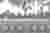 The image depicts a grayscale view of a cemetery with rows of headstones stretching into the distanc