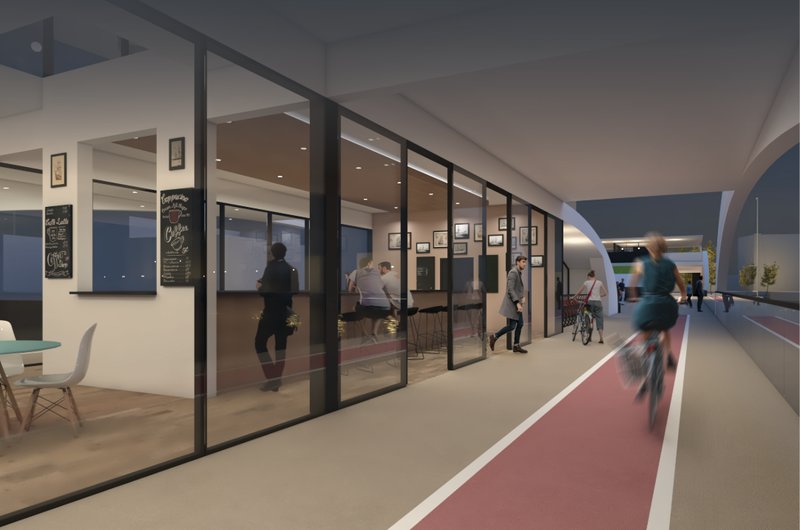 Ground-level cycle path and pedestrian zone with adjacent café, creating an active social corridor within the bridge.