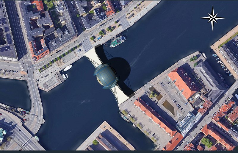 Aerial view revealing the bridge as a geometric urban landmark connecting both riverbanks.