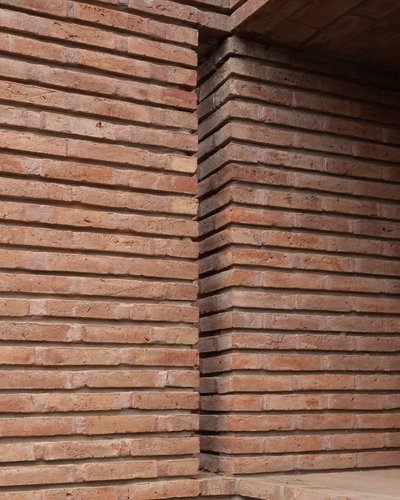 This architectural image showcases a close-up of a brick wall with a distinctive horizontal layering