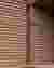 This architectural image showcases a close-up of a brick wall with a distinctive horizontal layering