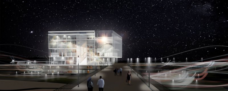 Illuminated façade transforming the science center into a luminous civic landmark along the riverfront.