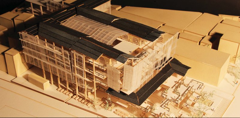 Physical model highlighting structural intervention and layered rooftop configuration within the urban fabric.