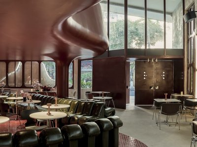 1.61 Design Workshop Wraps a 600-Square-Meter Café in Vietnam in Sculptural Burgundy Drama