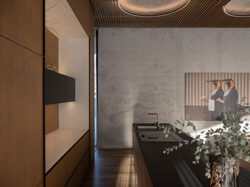 Kitchen with black countertop and concrete wall panels beneath a timber slat ceiling