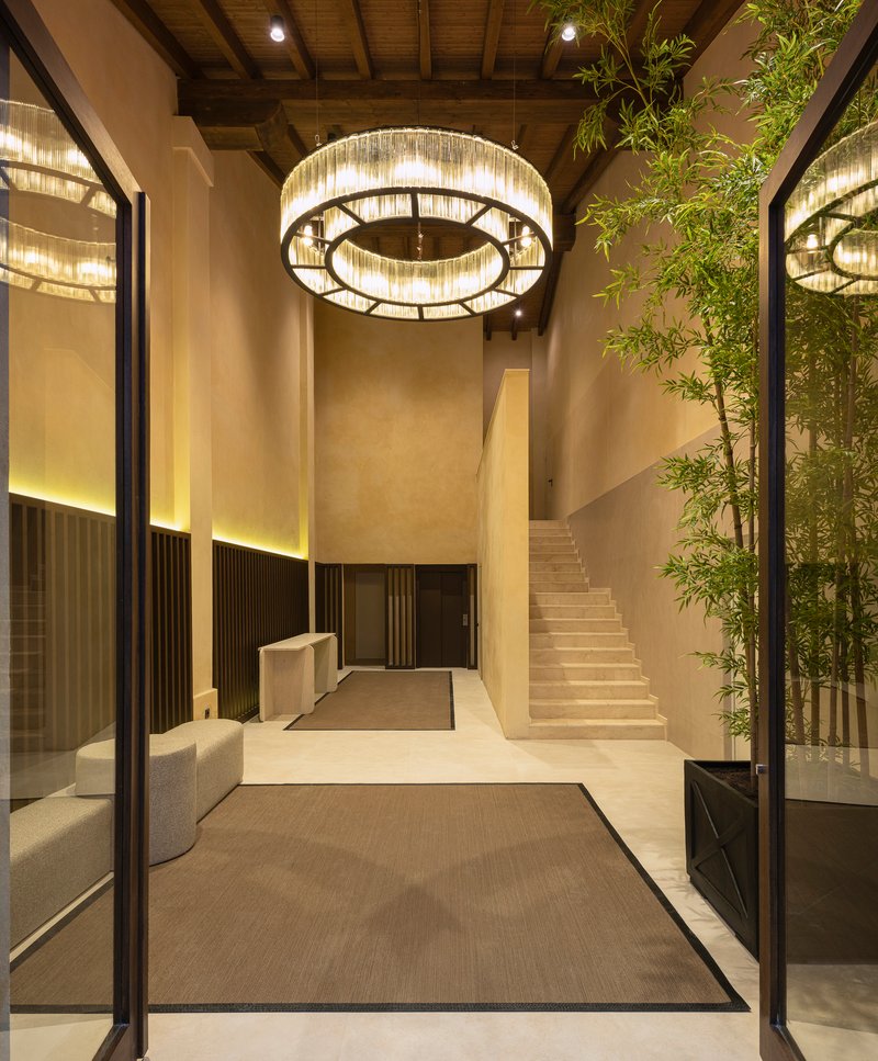 Reception lobby with circular crystal chandelier and bamboo planting