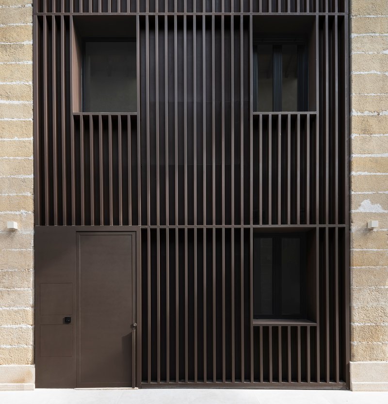 Close-up of dark timber slat screen with recessed openings