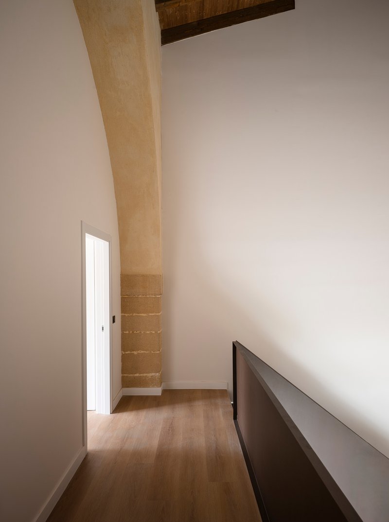 Upper interior with sandstone arch and original timber ceiling beams