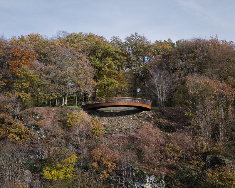 Distant view of the lookout sitting on a forested ridge in autumn