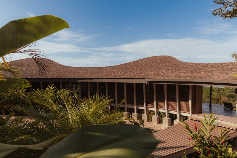 Side elevation showing the three peaks of the undulating roof above the open ground floor