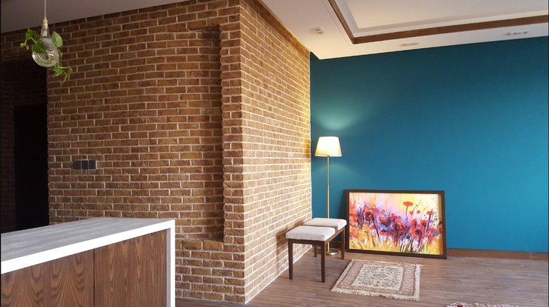 A refined corner composition where brick, wood, and color create a balanced residential interior experience.