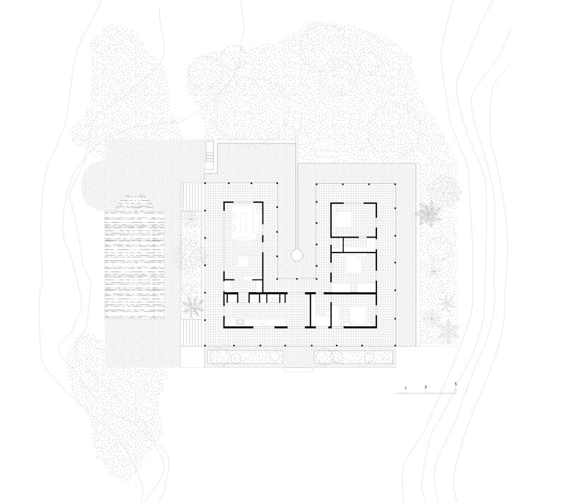 Floor plan drawing showing a square structure with central courtyard surrounded by landscape and trees