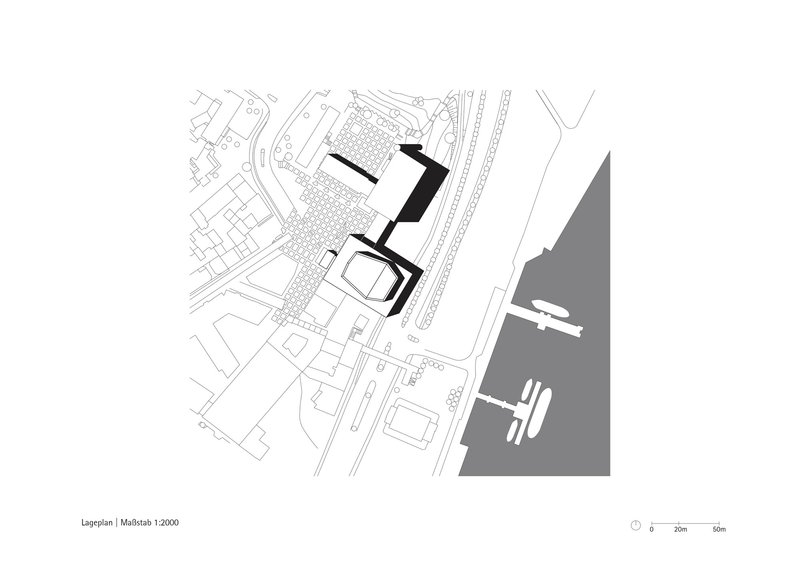 Site plan drawing showing building footprint adjacent to waterfront with surrounding urban grid