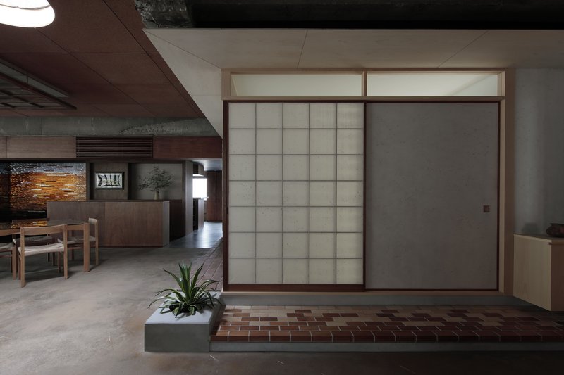 Closed translucent panel beside open shoji screen revealing the interior dining space beyond