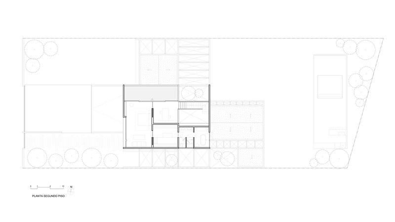 Second floor plan drawing showing compact interior rooms and adjacent terrace with planted trees