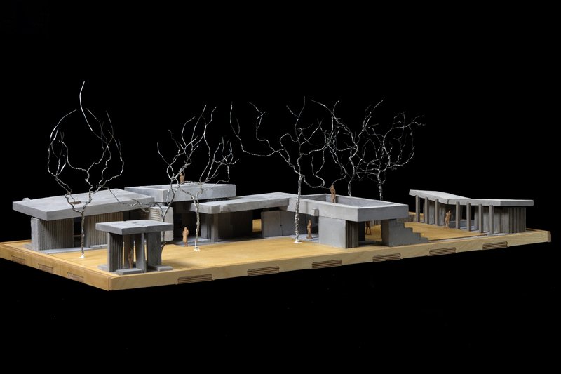 Physical model angled view revealing the connected pavilion roofs and open colonnade at right