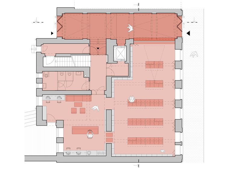 Floor plan drawing with spaces shaded in pink showing a gallery hall, staircase, and restroom facilities
