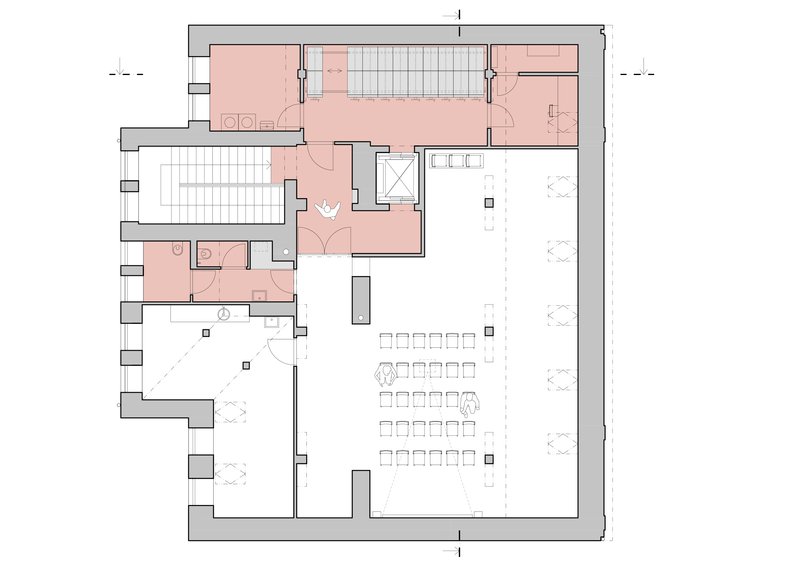 Floor plan showing a large open space with rows of seating and salmon-colored service areas along the perimeter