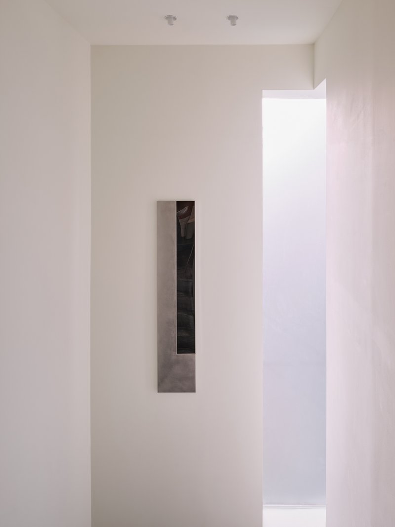 Close-up of the inset mirrored panel on the upper-floor wall