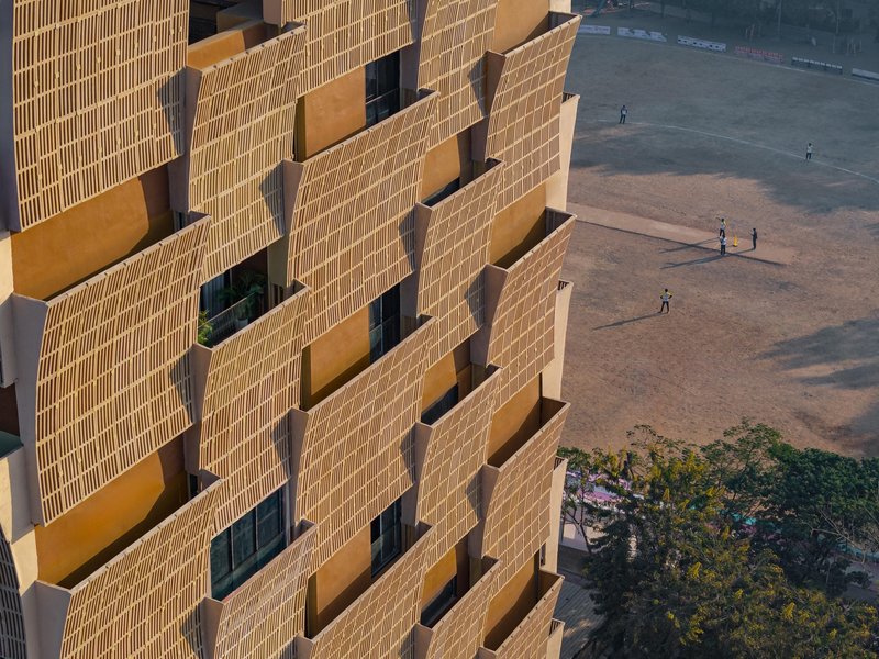 Aerial view of the protruding brick screens with figures on the paved ground below