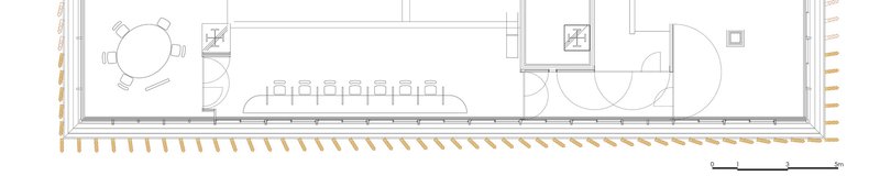 Floor plan drawing showing an elongated interior with round table, long dining table, and bathroom fixtures