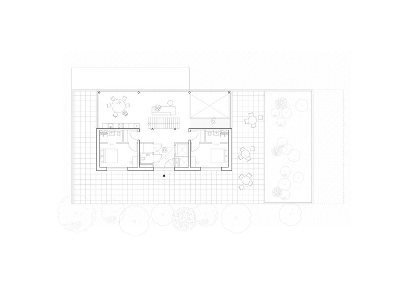 Upper floor plan drawing showing two bedroom suites flanking a central landing with exterior decks