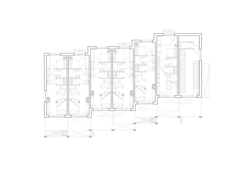 Floor plan drawing showing a row of four residential units with small planted areas at their entrances