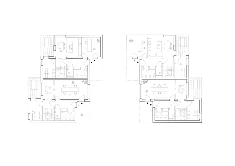 Floor plan drawing of two mirrored residential units with central staircases and balconies