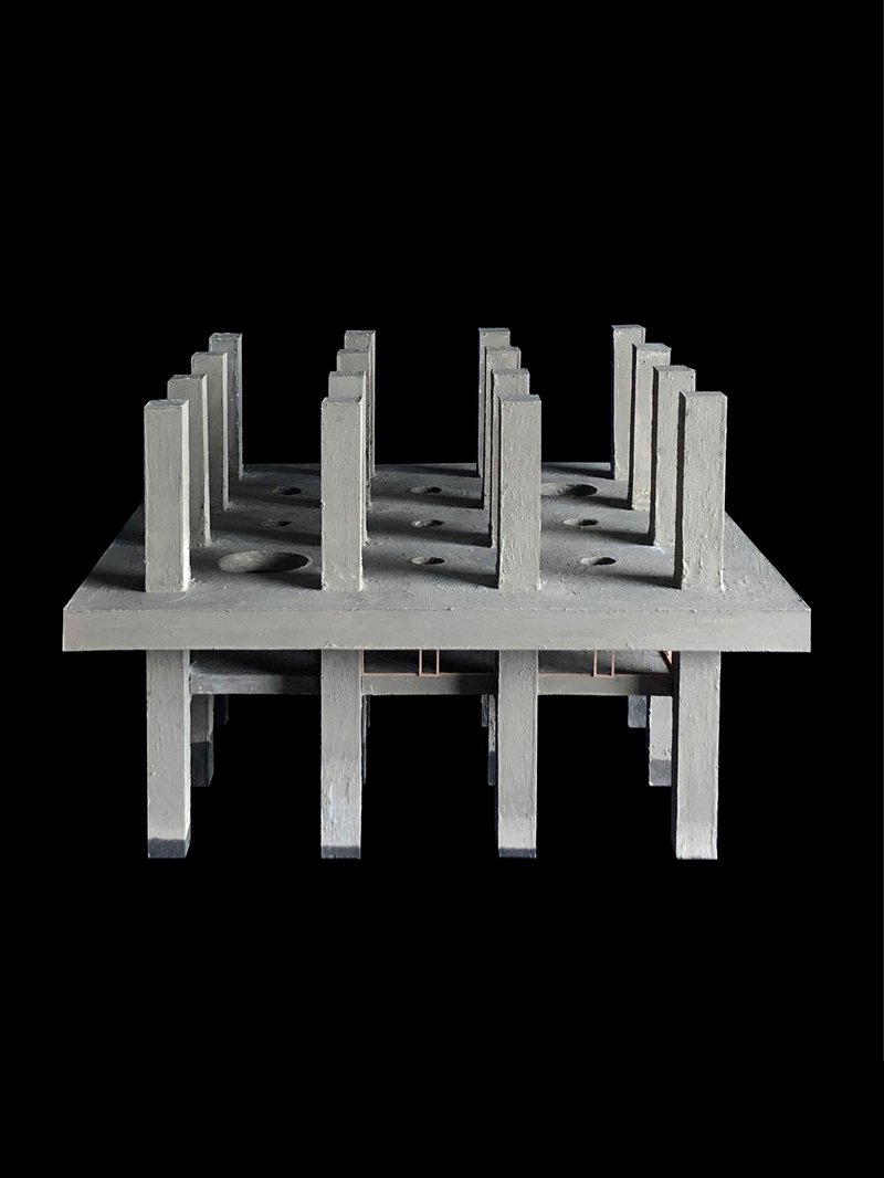 Physical model showing rows of vertical fins casting shadows across the elevated platform