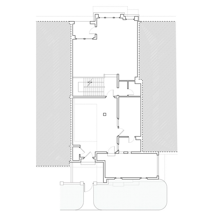 Floor plan drawing showing a central staircase with adjacent rooms and outdoor terraces