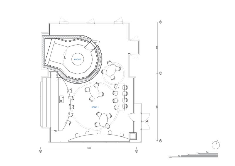 Floor plan drawing showing a circular seating area with tables arranged around a curved service counter