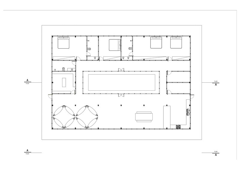 Floor plan drawing depicting rectangular layout with central gathering space and perimeter sleeping rooms