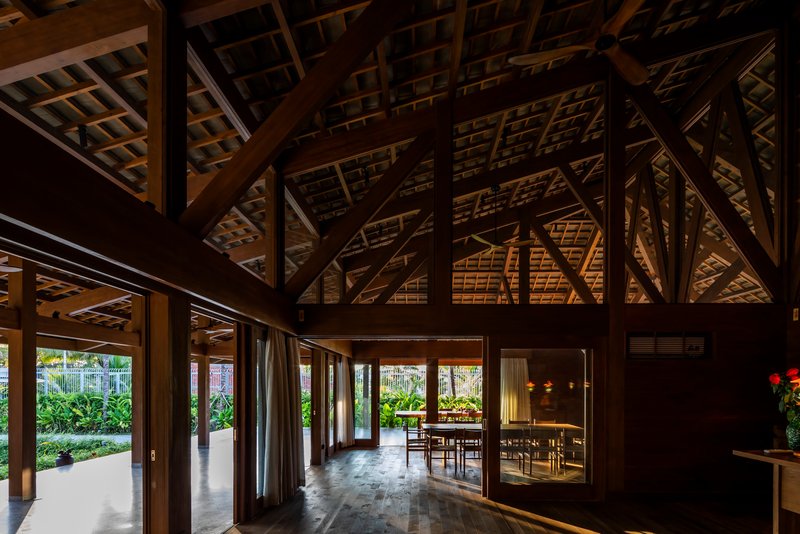 Interior view of the timber-framed dining hall illuminated at dusk