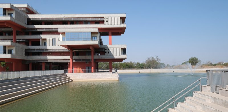 Long elevation along the lake showing the stepped concrete and red volumes