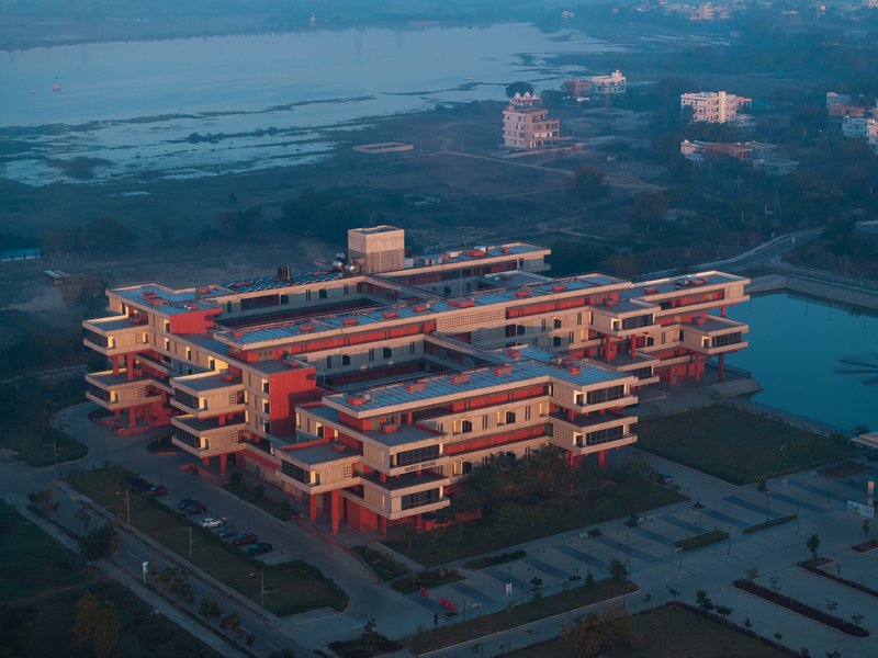 Aerial dusk view of the guest house complex with the campus lake behind