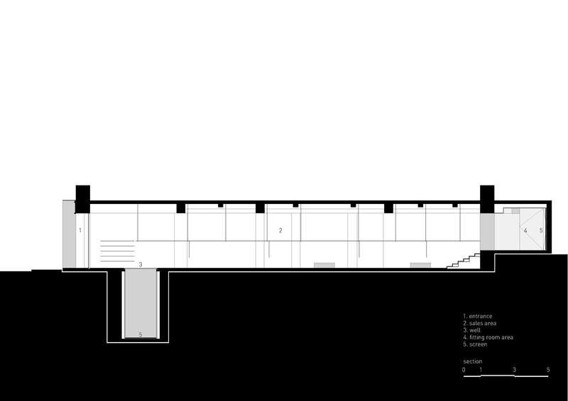 Section drawing revealing the split-level interior with sunken entrance and mezzanine storage above