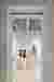 This architectural image showcases the interior of a museum or gallery space, viewed through a doorw