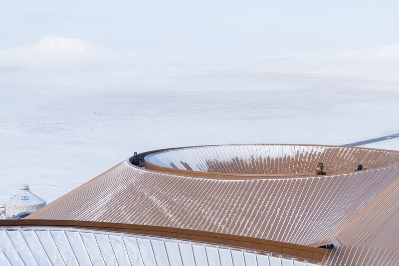 Rooftop close-up showing the radial timber roof structure with two skylights
