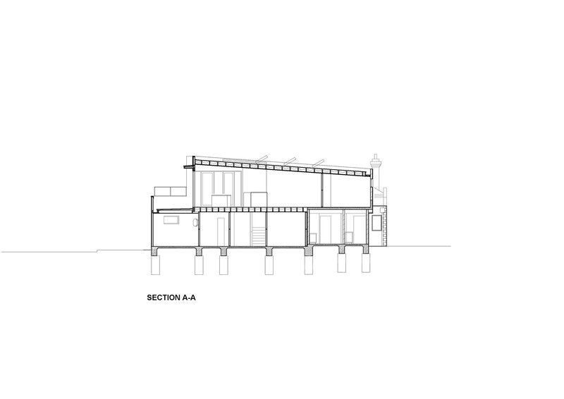 Section drawing showing interior spaces, timber framing, and raised foundation piers below the floor level