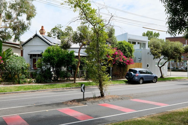 Streetscape showing the residence among traditional houses and established trees