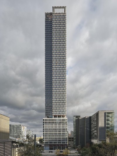 This architectural image showcases a tall, modern skyscraper with a distinctive grid-like facade. Th