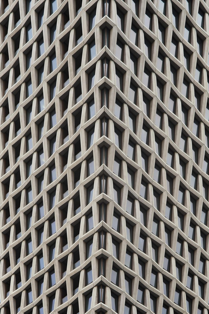 Close-up of the diagonal zigzag precast concrete panels forming the tower facade pattern