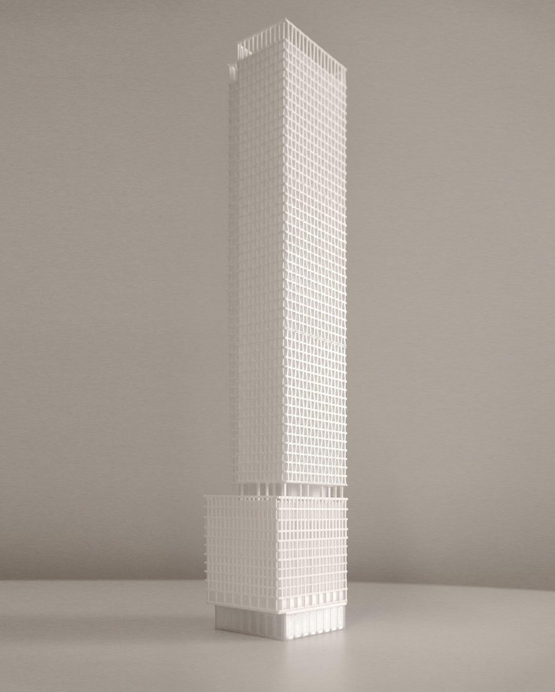 White physical model of a slender tower with gridded facade and recessed podium base
