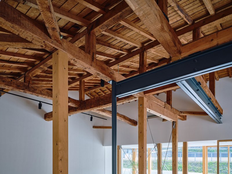 Detail of the exposed timber post and beam structure with steel reinforcement plates and cable tension elements